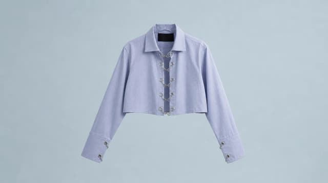 A cropped lilac shirt photographed flat on a pale background